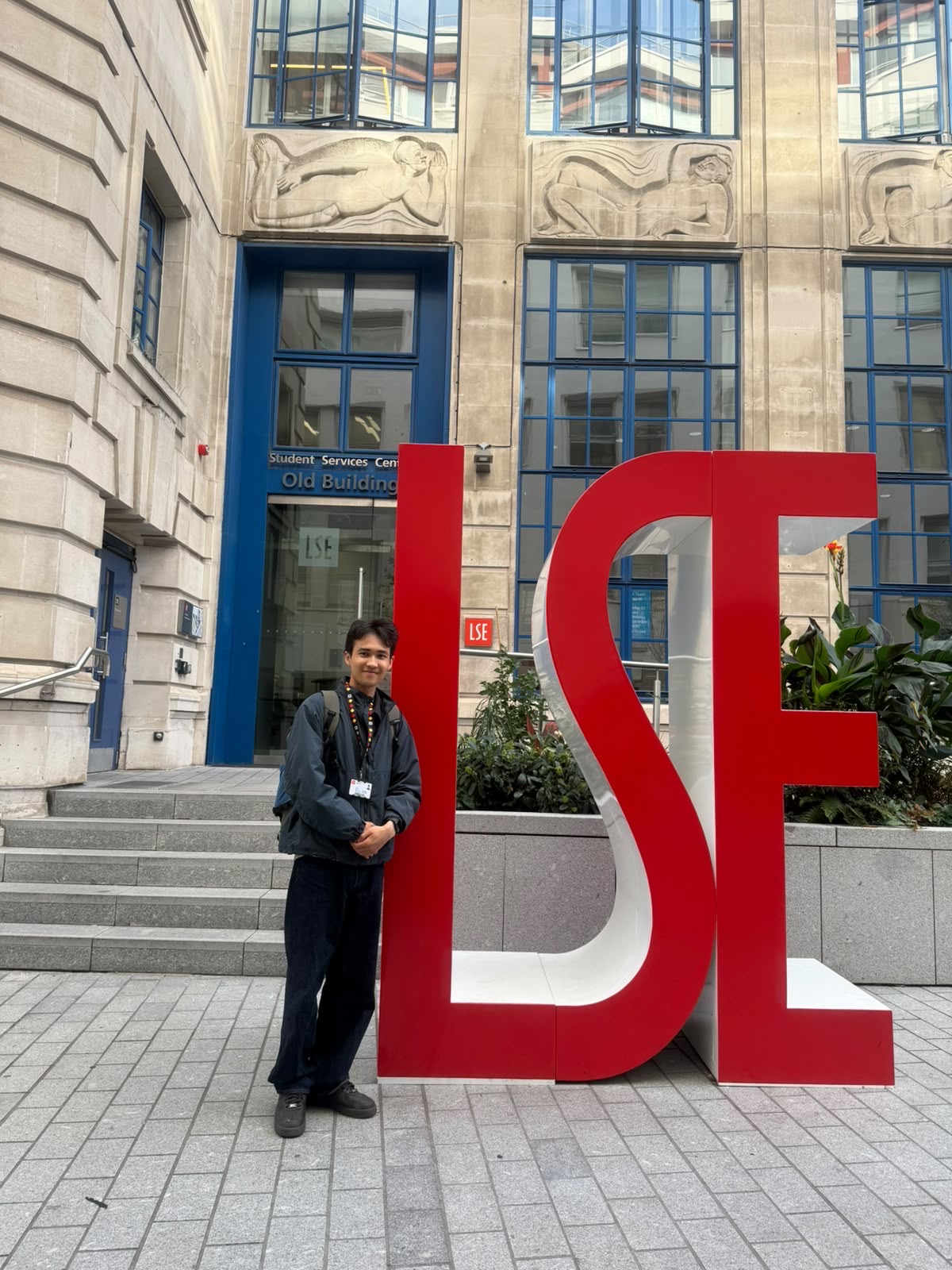 John Sovet beside the LSE sign outside the Old Building in London