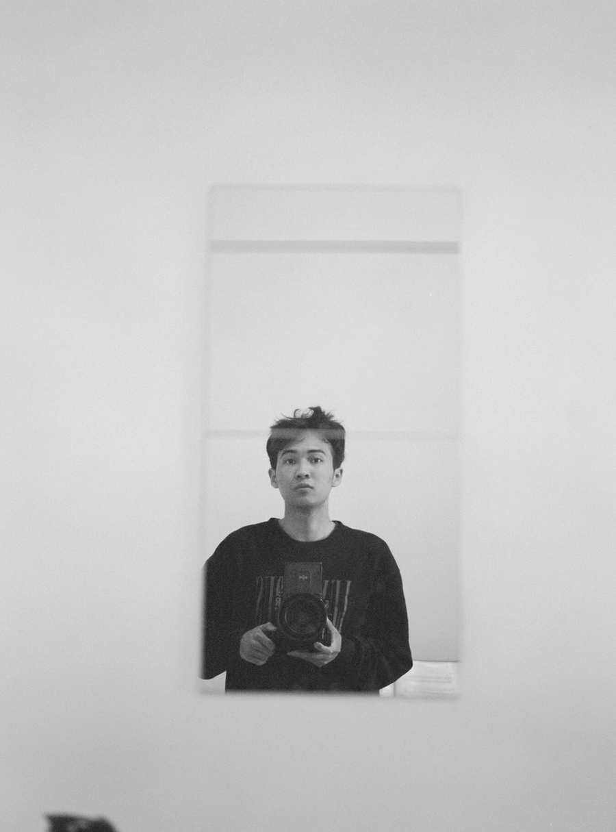 Mirror self-portrait with film camera